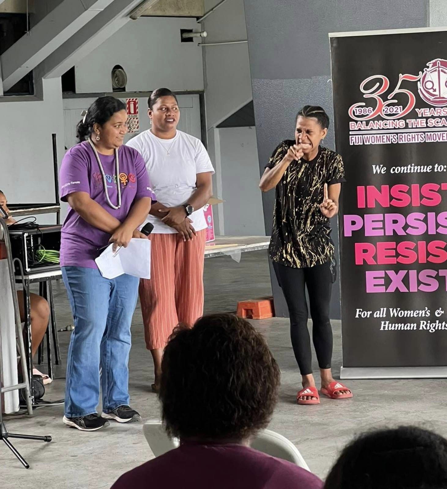 Speakers at FWRM's intergenerational panel. One of them is communicating with the crowd using Fijian Sign Language.