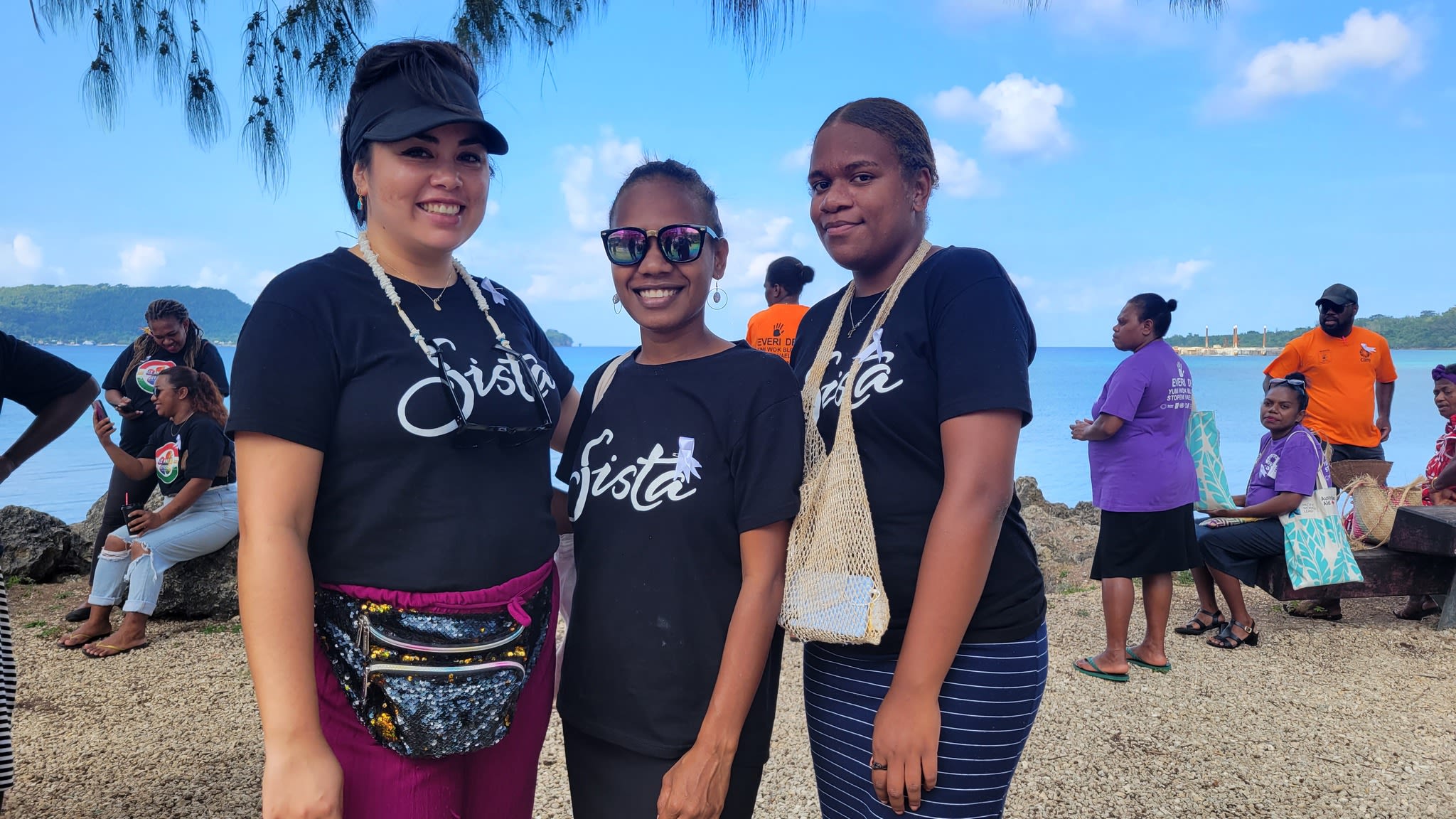 Sista staff members posing together. They are wearing black t-shirts with the Sista logo on the front.
