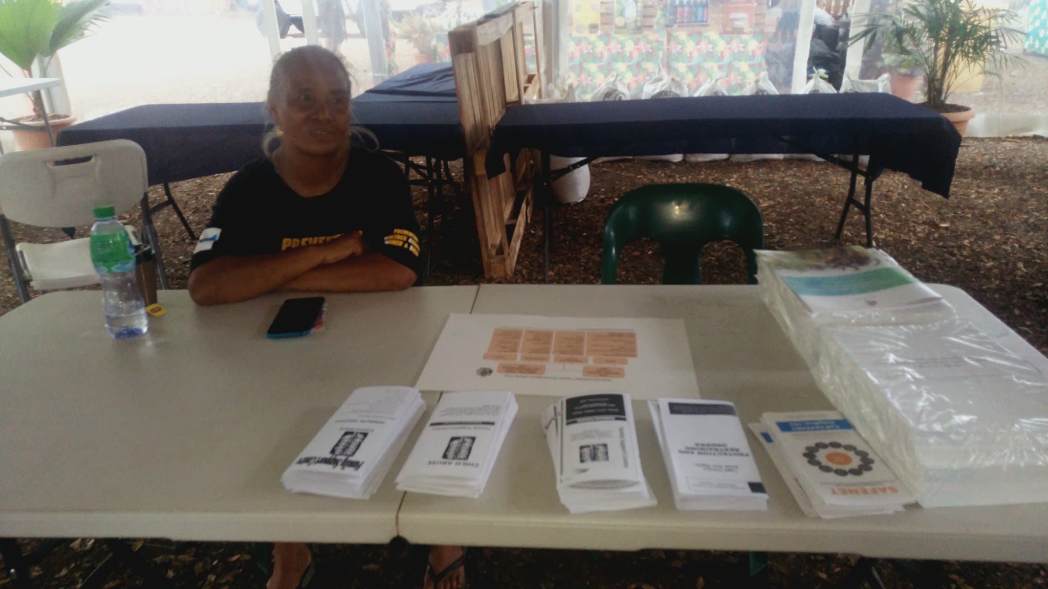 A table covered in brochures about violence against women and girls.