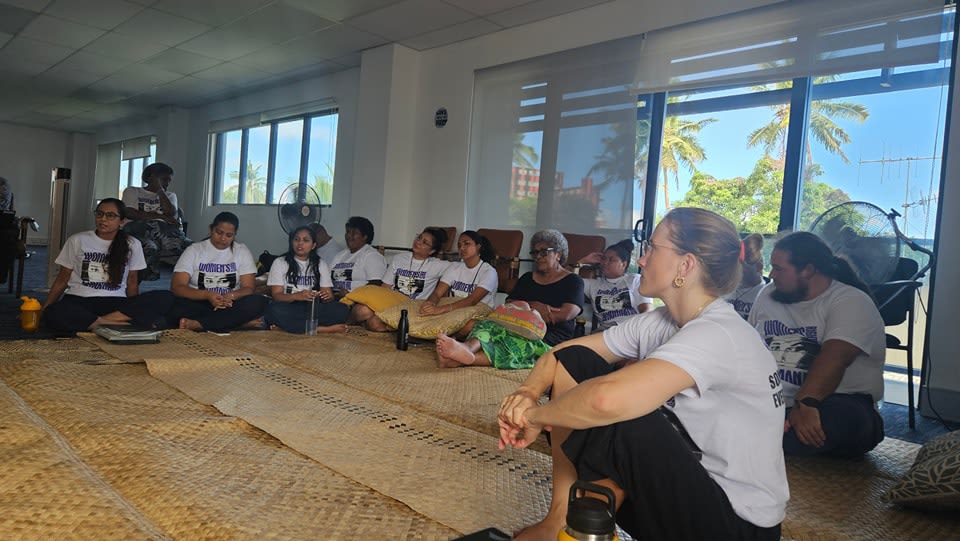 GIZ Pacific staff members sitting together on woven mats as they take part in FWRM's workshop.