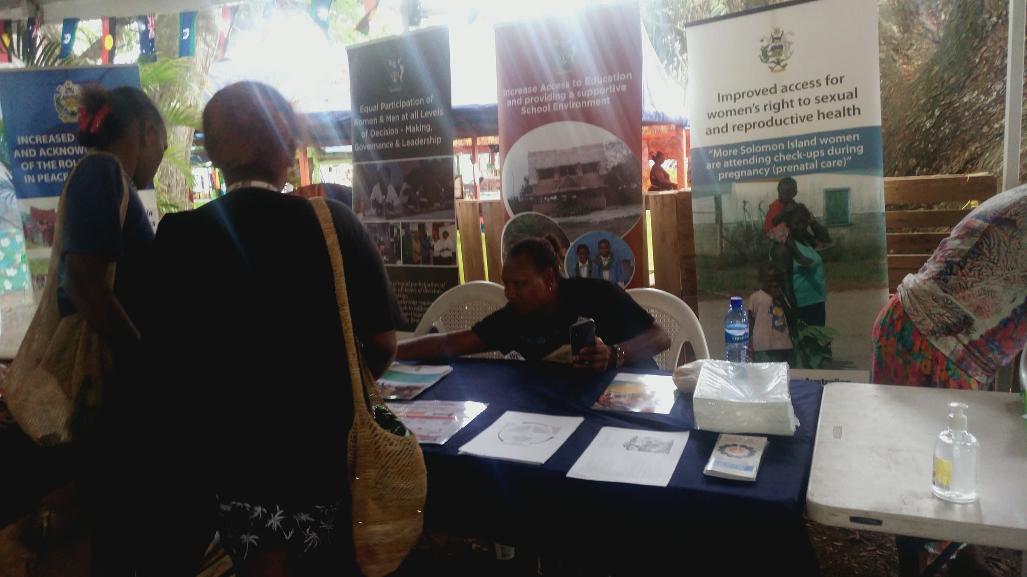 A group of people at Family Support Centre's table surrounded by banners and pamphlets.