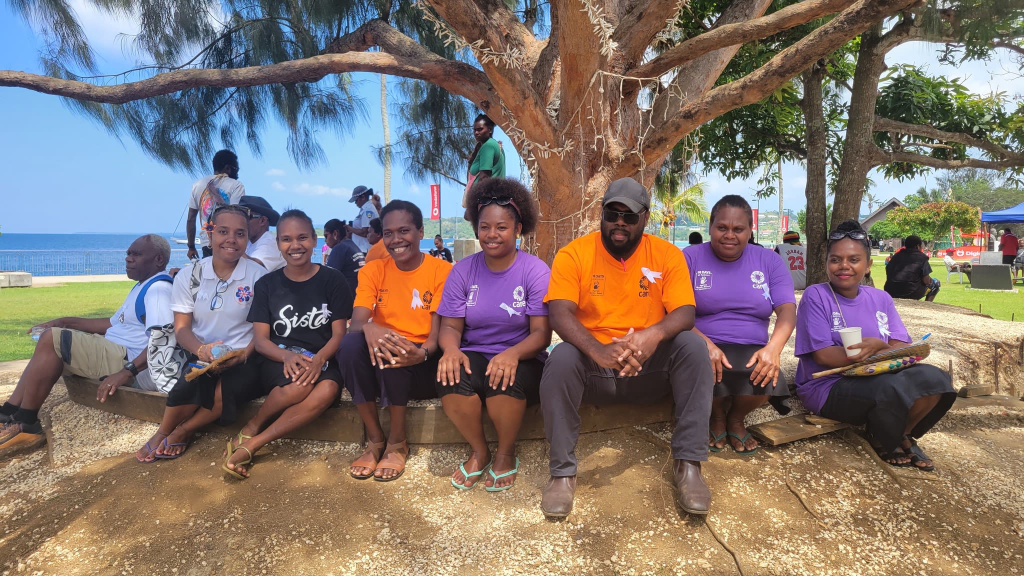 A group of people at the White Ribbon march sitting together and posing for the camera.
