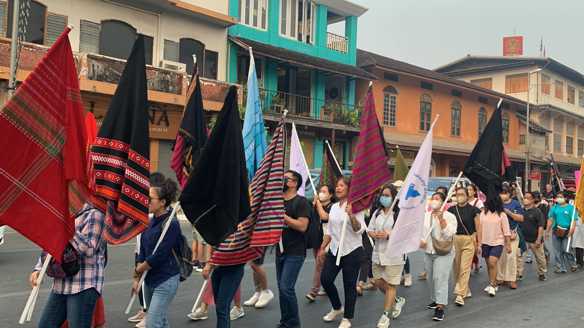 People marching in the streets holding up flags