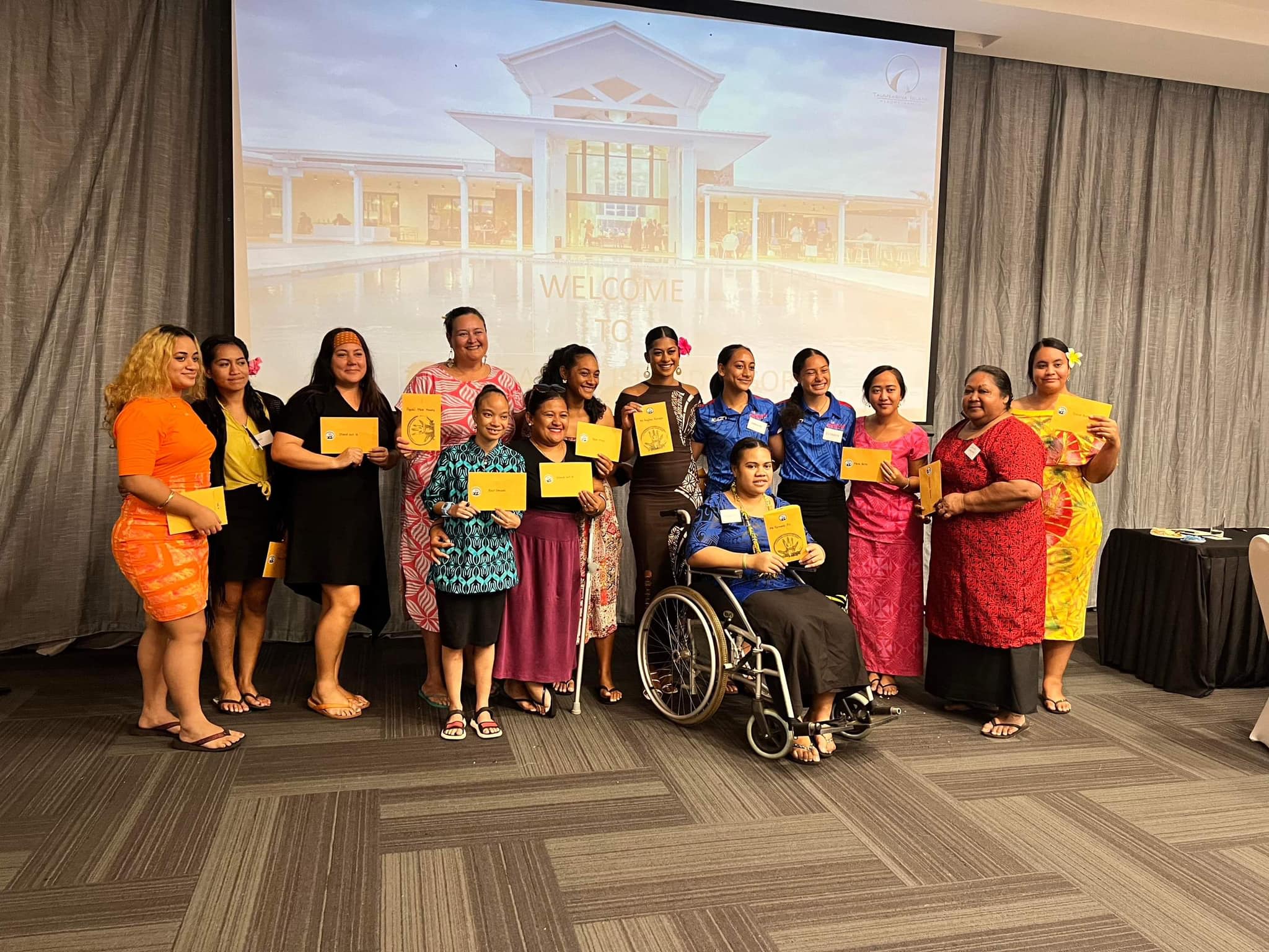 Participants at Brown Girl Woke's High Tea event posing for the camera. One of the participants is a wheelchair-user.